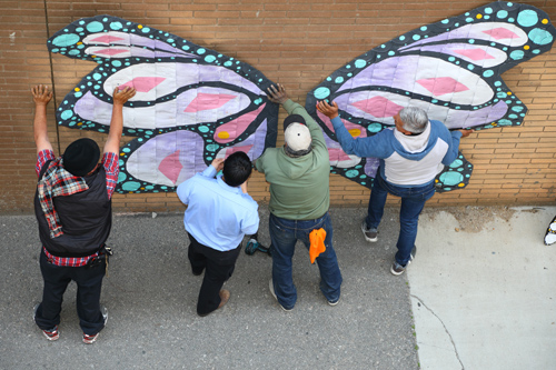 volunteers installing art piece