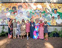 Artists standing in front of Rise Mural 